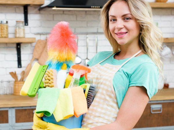 close-up-woman-holding-bucket-cleaning-tools-products