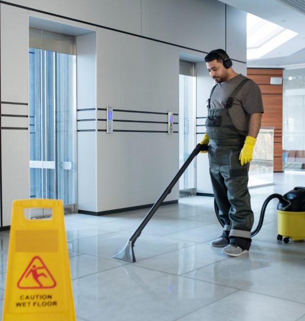 full-shot-man-vacuuming-floor